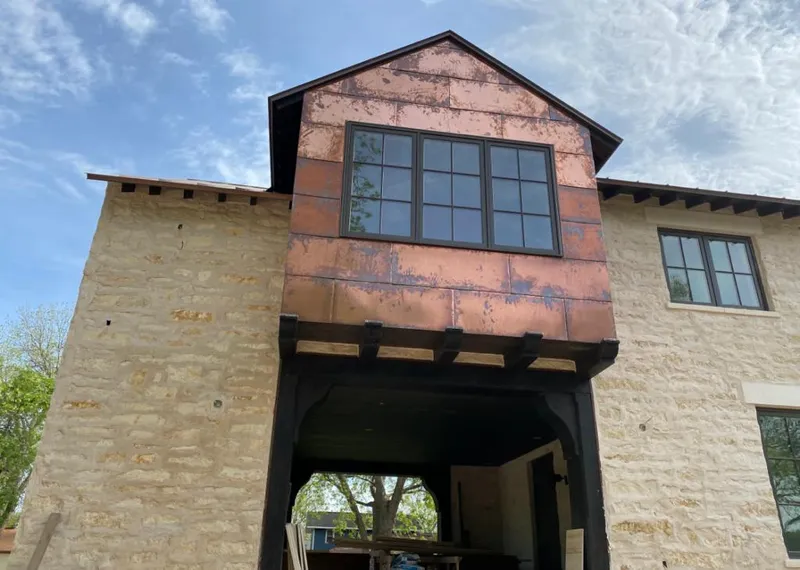 Copper metal panel facade on a stone building for Roof Repair in Montville